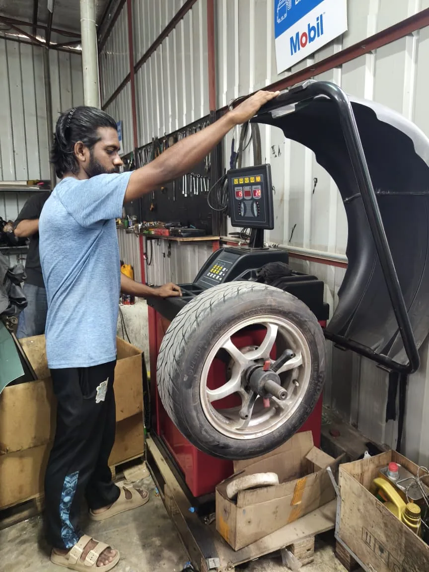 Mechanic setting a wheel on the balancing machine.