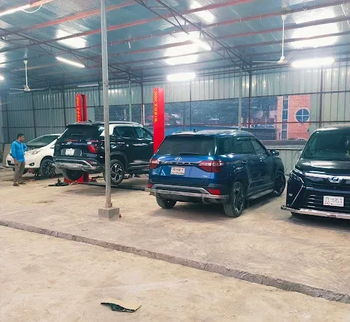Service bays with SUVs parked under the workshop shed.