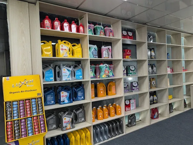 Shelves of engine oil cans in the workshop shop.
